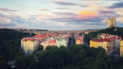 High angle view of trees and buildings against sky during sunset