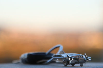 Close-up of airplane toy with keyring on table