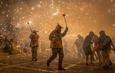 Group of people in traditional clothing at night