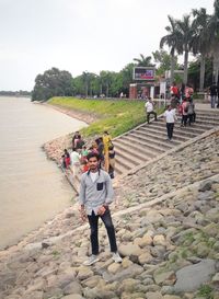 People standing on land against sky