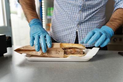 Midsection of man preparing food