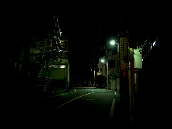 Illuminated city street at night