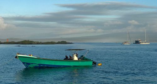 Boat moored on sea against sky