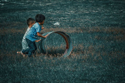 Boy playing with ball on grass