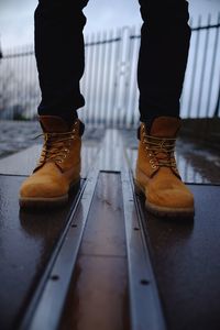 Low section of woman standing on tiled floor