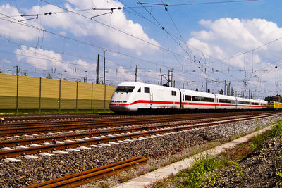 Passenger trains on tracks against sky