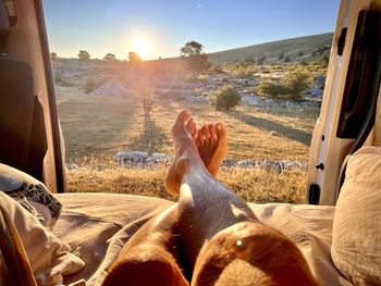 Low section of man relaxing in van