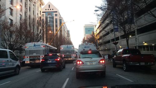 Cars on street amidst buildings in city