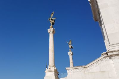 Low angle view of statue against blue sky