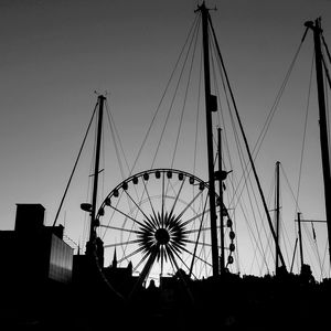 Low angle view of silhouette ferris wheel against sky