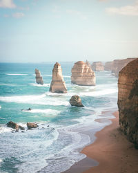 Rocks in sea against sky