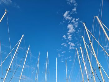 Low angle view of sailboat against blue sky