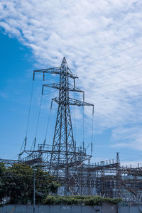 Low angle view of electricity pylon against sky