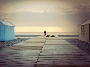 Pier on sea at sunset