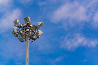 Low angle view of street light against blue sky
