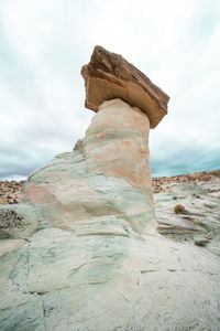 Low angle view of rock formation against sky