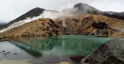 Smoke emitting from volcanic landscape