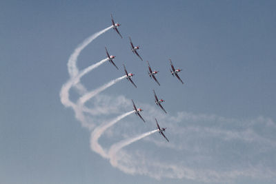 Low angle view of airplane flying against sky