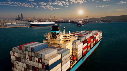 Panoramic view of commercial dock by sea against sky