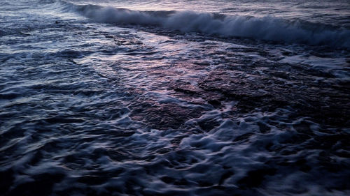 High angle view of waves rushing towards shore