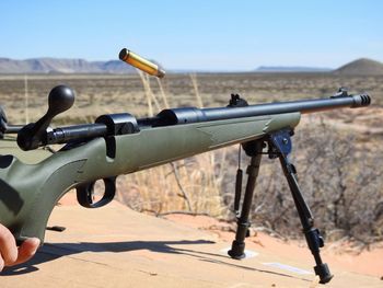 Rifle against clear blue sky during sunny day