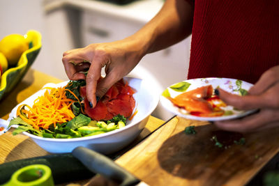 Latin woman cooking a salad for her diet