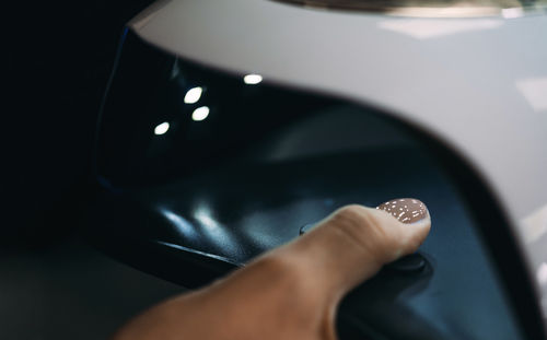 Cropped hand of person holding car