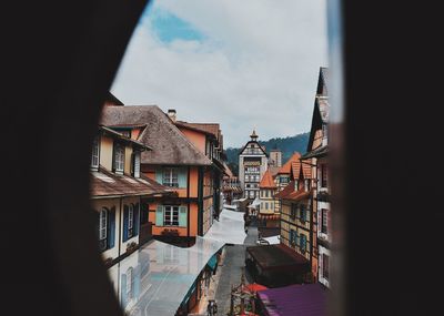 Buildings in town against sky