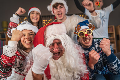 Group of fans watching a sporting event sitting on the sofa in their living room