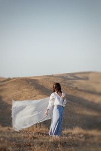 Rear view of a woman standing on land