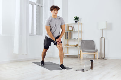 Full length of woman exercising in gym
