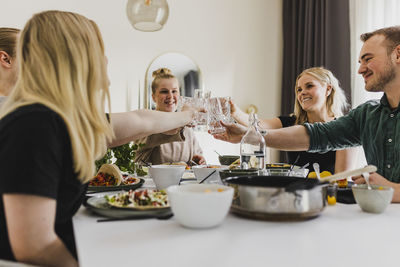 Group of friends raising toast during mexican feast