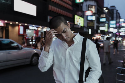 Man walking in city at night