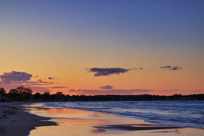 Scenic view of beach against sky during sunset