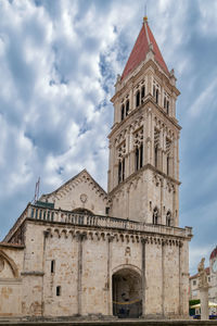 Low angle view of historic building against cloudy sky