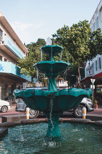 View of fountain in city against sky