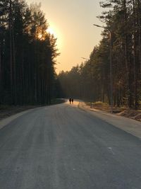 People walking on road during sunset