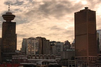 City skyline against cloudy sky