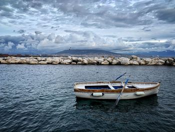 Boat moored on sea against sky