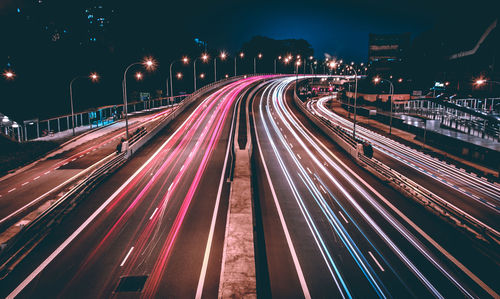 High angle view of light trails on road at night