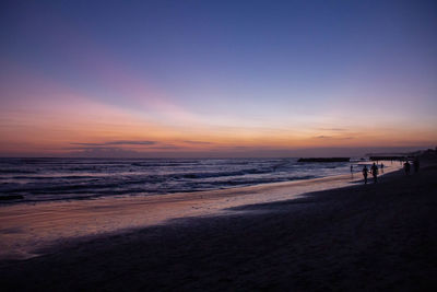 Scenic view of beach against sky during sunset