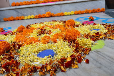 Close-up of yellow flowers on floor for sale