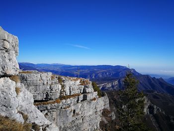 Scenic view of mountains against blue sky