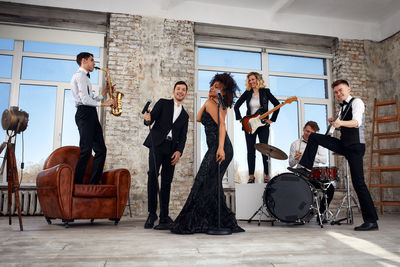 Female friends using mobile phone while sitting at home