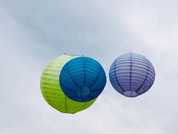 Hanging colorful paper balls decoration with dark storm sky in the background