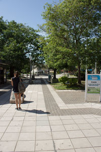 Man walking by trees