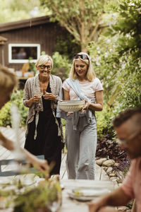 Family enjoying during garden party in back yard