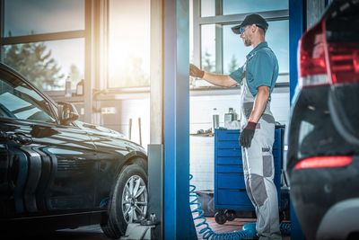 Side view of mechanic standing at garage