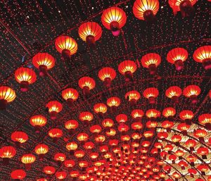 Low angle view of illuminated lantern against sky at night