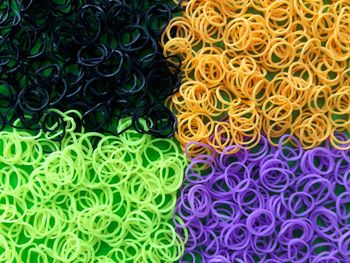 Full frame shot of multi colored rubber bands on table for sale